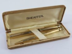 A Shaeffer fountain and ball point pen set, the fountain pen having 14ct gold nib,