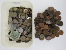 A large quantity of 20thC world coinage together with an HM silver ARP badge.