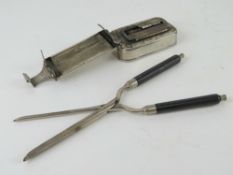 A pair of vintage hair curling tongs complete with spirit heater.