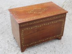 A 20th century Indo Asian lidded trunk inlaid with brasswork and measuring 76 x 45 x 52cm.