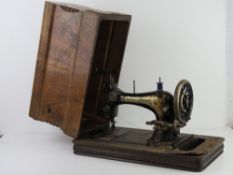 A vintage sewing machine by Frister and Rossmann in original case (case a/f).