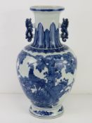 A late 19th / early 20th century blue and white Oriental baluster vase, unsigned, 38cm high.