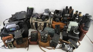 A large collection of vintage and contemporary cameras and binoculars inc Canon AE-1,