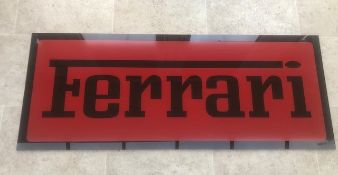 A large Ferrari-themed garage wall sign.
