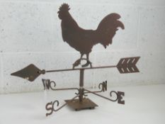 A weather vane having cockerel upon, arrow measuring 55cm in length, standing approx 42cm high.