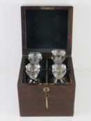 A fine Victorian rosewood tantalus having flush fitting swing handle to the lid,