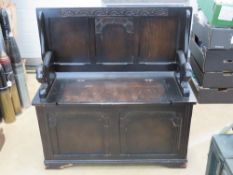 A late 20th century Monks bench having carved lion design arms, 95 x 42cm.