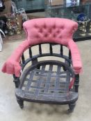 A late Victorian tub armchair raised over turned legs terminating in castors, for re-upholstery.