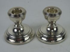 A pair of HM silver short candlesticks, hallmarked for Birmingham.