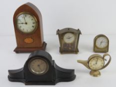 An ebonised small size mantle clock having brass chaptering together with an Edwardian arch top