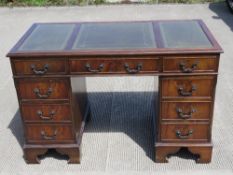 A reproduction Georgian style green leather topped pedestal desk, 120 x 60 x 78cm.