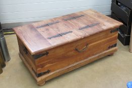 A Mexican pine coffee table having black painted iron corner bracing and lift up lidded compartment
