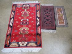 A woollen prayer rug in blue and red ground 65 x 30cm, together with an Agadir 'silk effect' rug,