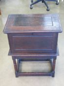 An oak cabinet lid lifting to reveal compartment within, having brass lock with key, 51.