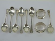 A set of six hallmarked silver teaspoons together with a jam spoon and a napkin ring each