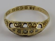 A five stone diamond carved head 18ct gold ring, hallmarked for Chester 1914, size O-P, 2.2g.