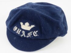A cloth scholars cap as retailed by Castell and Son Broad street Oxford.