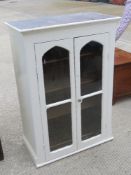 A Victorian two door glazed and painted hanging bookcase doors opening to reveal shelves within,