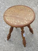 A single inlaid Indo Asian side table raised over four turned legs profusely decorated with brass
