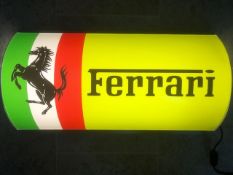 A contemporary Ferrari-themed illuminated and barrel-fronted wall sign complete with switch,