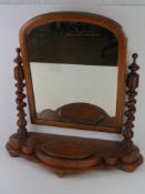 A large mahogany Victorian bedroom mirror raised over barleytwist supports upon the shaped base