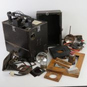 A vintage projector in original case, together with a box of 'photographic enlarging' equipment.