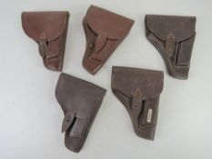 Five PPK leather holsters.
