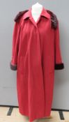 An Aqua Scutum of London felted coat with faux fur fringe in red, approx measurements 48