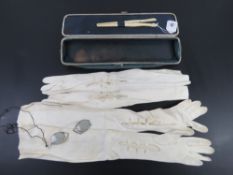 An antique expanding glove box opening to reveal bone glove stretchers,