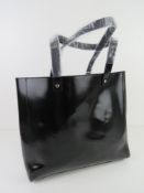 A black plasticised tote bag by Givenchy Paris approx 31cm wide.
