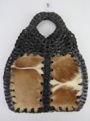 A vintage cow hide and leather handbag approx 32cm wide.
