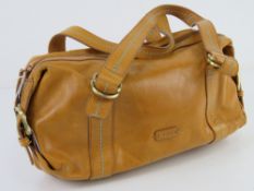 A leather handbag by Tula in mustard yellow, approx 28cm wide.