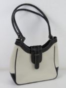 A white and black leather handbag by Joshua Taylor approx 25cm wide.