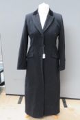 A black felted woolen ladies coat having velvet collar, labels removed,
