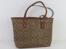 A Coach handbag some wear noted to corners, approx 37cm wide.