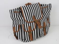 An 'as new' ruck sack in black and white striped pattern approx 33 x 34cm.
