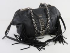 A black handbag by Guess approx 27cm wide. Some wear noted.