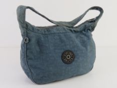 A blue canvas Kipling bag approx 27cm wide.