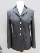A Dublin Ashby riding jacket having horse head design buttons and velvet collar,