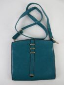 A turquoise shoulder bag by Bella approx 22cm wide.