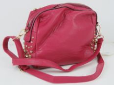 An 'as new' pink studded handbag handbag 19 x 17cm.