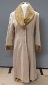 A wool and cashmere coat by Berghaus, size 14, having faux fur collar and cuffs,