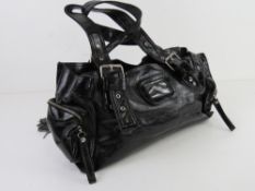 A black patent handbag by Kookai approx 38cm wide, some wear noted to corners.