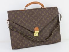 A vintage brief case bearing labels for Louis Vuitton having stud for Louis Vuitton,