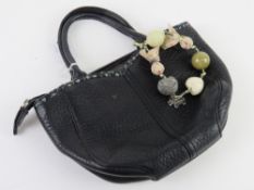 Radley; a small black leather handbag with key chain upon approx 19cm wide.