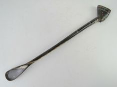 A long shoe horn surmounted by Nefertiti type head and formed from horn throughout, 54cm in length.