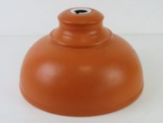 A contemporary orange painted industrial lamp shade, 29cm dia.