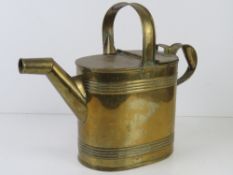 A vintage brass 6 pint water can believed to be of early automotive origin.