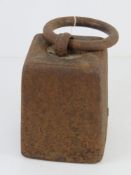 A cast iron weight with loop handle, for use as a door stop standing approx 23cm high.