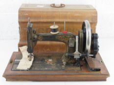A vintage sewing machine having floral decoration and mother or pearl inlay,